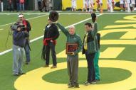 Richard lariviere waving to crowd on field at OSU game